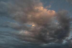 Cloudscape, Colored Clouds at Sunset near the Ocean in a Cloudy Day photo