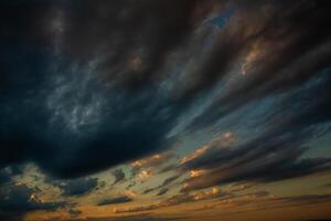 Cloudscape, Colored Clouds at Sunset near the Ocean in a Cloudy Day photo