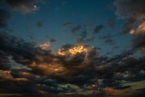 Cloudscape, Colored Clouds at Sunset near the Ocean in a Cloudy Day photo