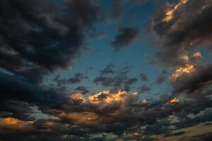 Cloudscape, Colored Clouds at Sunset near the Ocean in a Cloudy Day photo