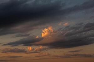 Cloudscape, Colored Clouds at Sunset near the Ocean in a Cloudy Day photo