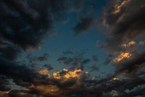 Cloudscape, Colored Clouds at Sunset near the Ocean in a Cloudy Day photo
