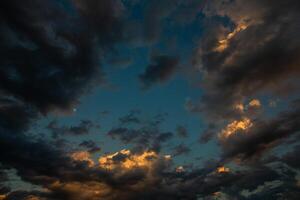 Cloudscape, Colored Clouds at Sunset near the Ocean in a Cloudy Day photo