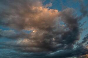 Cloudscape, Colored Clouds at Sunset near the Ocean in a Cloudy Day photo