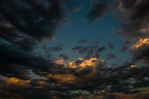 Cloudscape, Colored Clouds at Sunset near the Ocean in a Cloudy Day photo