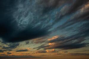 Cloudscape, Colored Clouds at Sunset near the Ocean in a Cloudy Day photo