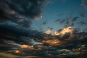 Cloudscape, Colored Clouds at Sunset near the Ocean in a Cloudy Day photo