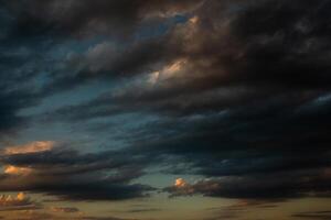 Cloudscape, Colored Clouds at Sunset near the Ocean in a Cloudy Day photo