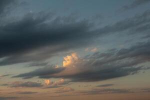 Cloudscape, Colored Clouds at Sunset near the Ocean in a Cloudy Day photo