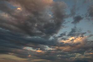 Cloudscape, Colored Clouds at Sunset near the Ocean in a Cloudy Day photo