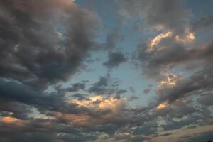 Cloudscape, Colored Clouds at Sunset near the Ocean in a Cloudy Day photo