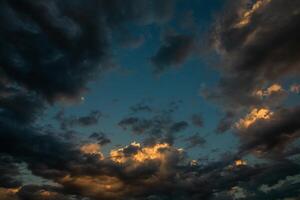 Cloudscape, Colored Clouds at Sunset near the Ocean in a Cloudy Day photo