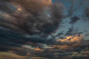 Cloudscape, Colored Clouds at Sunset near the Ocean in a Cloudy Day photo