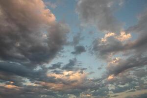 Cloudscape, Colored Clouds at Sunset near the Ocean in a Cloudy Day photo