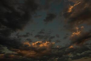 Cloudscape, Colored Clouds at Sunset near the Ocean in a Cloudy Day photo