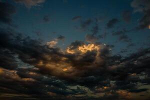 Cloudscape, Colored Clouds at Sunset near the Ocean in a Cloudy Day photo