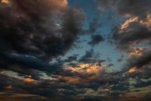 Cloudscape, Colored Clouds at Sunset near the Ocean in a Cloudy Day photo