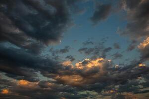 Cloudscape, Colored Clouds at Sunset near the Ocean in a Cloudy Day photo