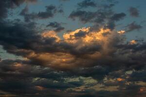 Cloudscape, Colored Clouds at Sunset near the Ocean in a Cloudy Day photo