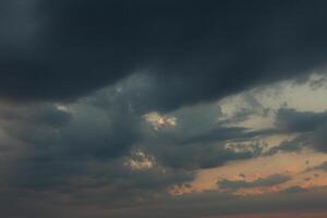 Cloudscape, Colored Clouds at Sunset near the Ocean in a Cloudy Day photo