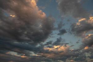 Cloudscape, Colored Clouds at Sunset near the Ocean in a Cloudy Day photo