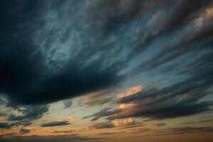 Cloudscape, Colored Clouds at Sunset near the Ocean in a Cloudy Day photo