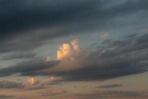 Cloudscape, Colored Clouds at Sunset near the Ocean in a Cloudy Day photo
