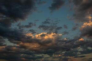 Cloudscape, Colored Clouds at Sunset near the Ocean in a Cloudy Day photo