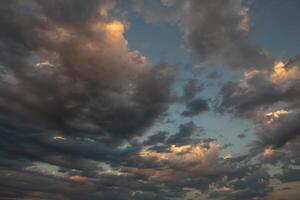Cloudscape, Colored Clouds at Sunset near the Ocean in a Cloudy Day photo