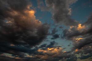 Cloudscape, Colored Clouds at Sunset near the Ocean in a Cloudy Day photo