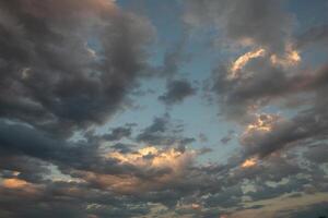 Cloudscape, Colored Clouds at Sunset near the Ocean in a Cloudy Day photo