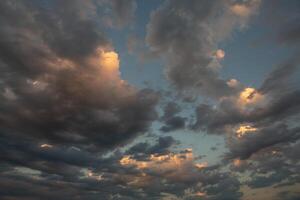 Cloudscape, Colored Clouds at Sunset near the Ocean in a Cloudy Day photo