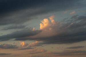 Cloudscape, Colored Clouds at Sunset near the Ocean in a Cloudy Day photo