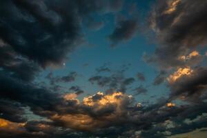 Cloudscape, Colored Clouds at Sunset near the Ocean in a Cloudy Day photo