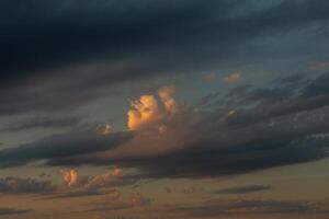Cloudscape, Colored Clouds at Sunset near the Ocean in a Cloudy Day photo