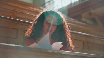 Hispanic woman girl student turning pages in textbook start learning in class lecture female study at table writing studying write learn course in college university sunny sunbeam auditorium education video
