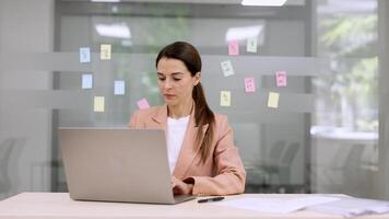 Business woman busy working on laptop computer at office. Sales representative, tech and telemarketing with portrait for communication, networking and negotiation video