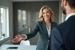 photo of woman in black blazer with open hand and colleagues in the office,