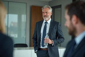 photo of man in outfit with hand giving bottle of water in the house,