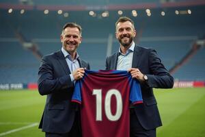 photo of coach and player holding shirt in the stadium field at signing contract event,