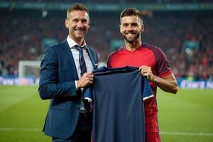 photo of coach and player holding shirt in the stadium field at signing contract event,