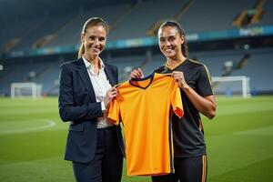 photo of coach and player holding shirt in the stadium field at signing contract event,