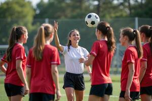 photo of coach instructor trainer teaching teenage player at soccer field,