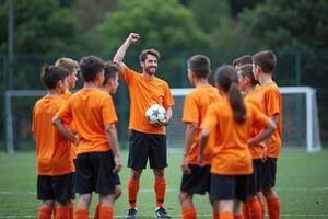 photo of coach instructor trainer teaching teenage player at soccer field,
