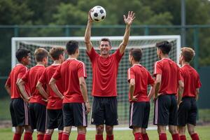 photo of coach instructor trainer teaching teenage player at soccer field,