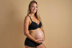 photo of pregnant woman standing pose with beige background,