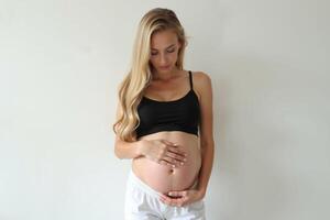 photo of pregnant woman standing pose on white background,