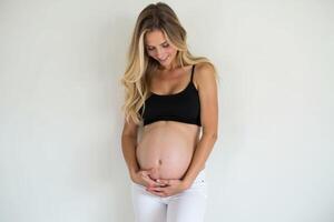 photo of pregnant woman standing pose on white background,