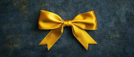 Yellow Satin Bow on Grunge Background photo