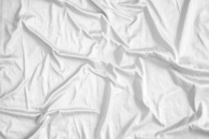 Abstract white wrinkled bedding sheet fabric texture background photo